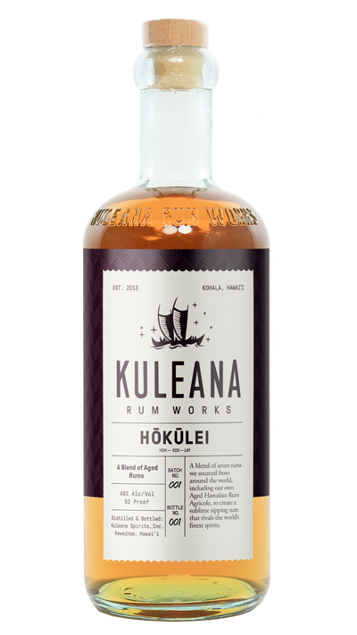 A bottle of Kuleana Rum Works Hóküliéi rum on a plain white background. The clear glass bottle shows the amber-colored liquid inside, topped with a light brown cork.